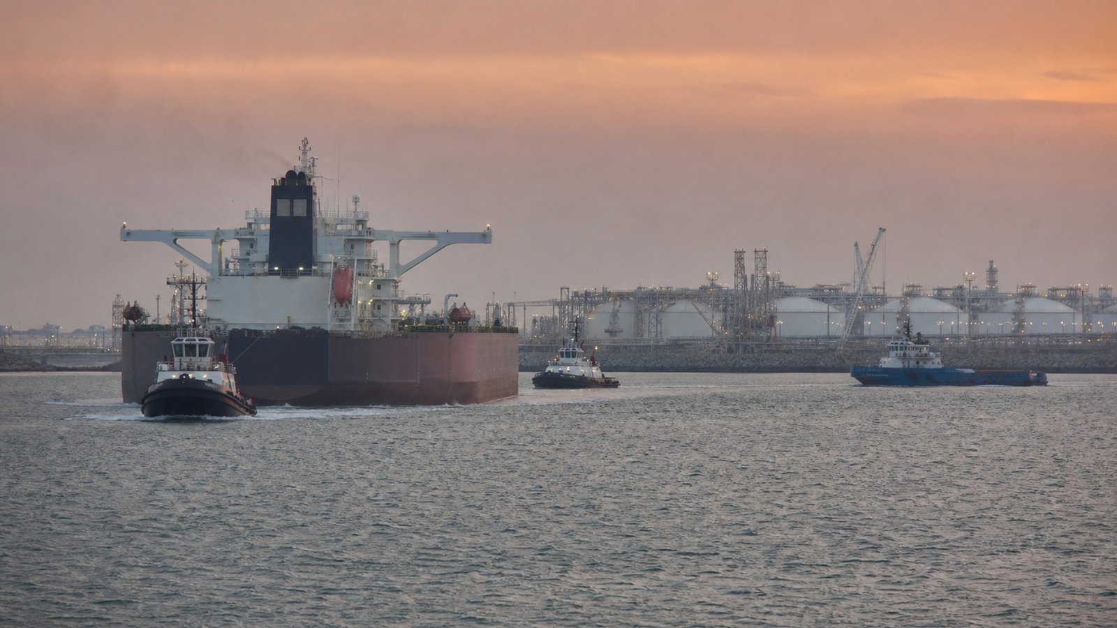Tanker and tug escort approaching a generic Gulf energy terminal